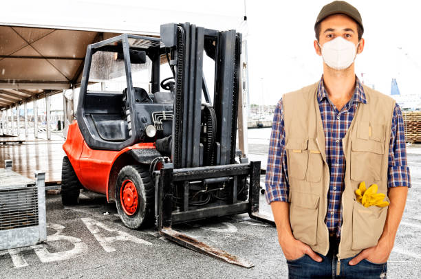istock Young man forklift driver wearing anti virus mask during working 1271918974