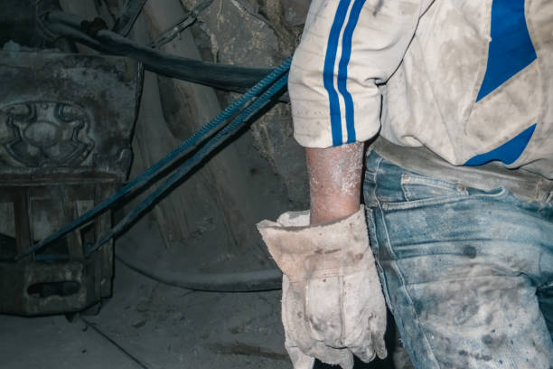 istock Gloved miner pulling a stone wagon with rope in a tunnel 1271920234