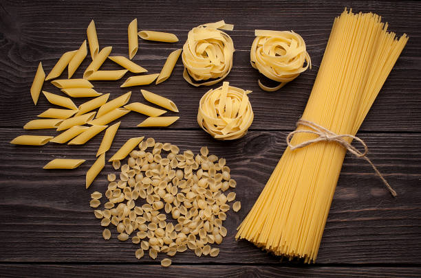 istock pasta on wooden background 1271920572