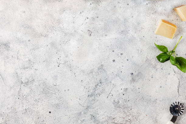 Top view of a light gray concrete table with cheese stock photo