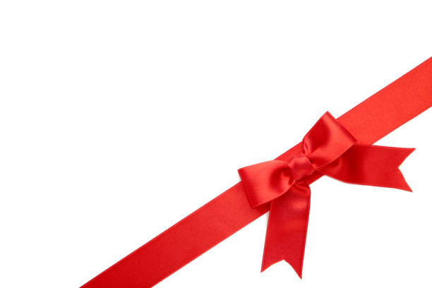 istock Red ribbon with bow with tails isolated on white background. 1271923511