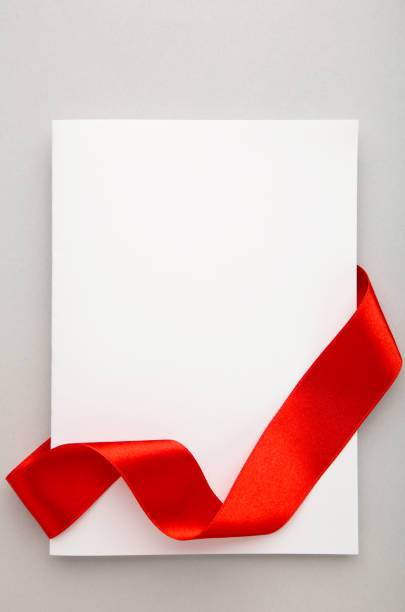 istock Close up of a note card with ribbon bow on grey background 1271923527