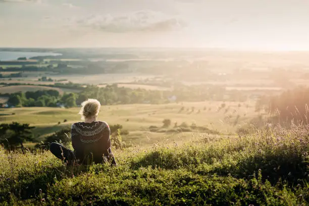 Photo of Portrait of a mature woman looking out over the countryside.