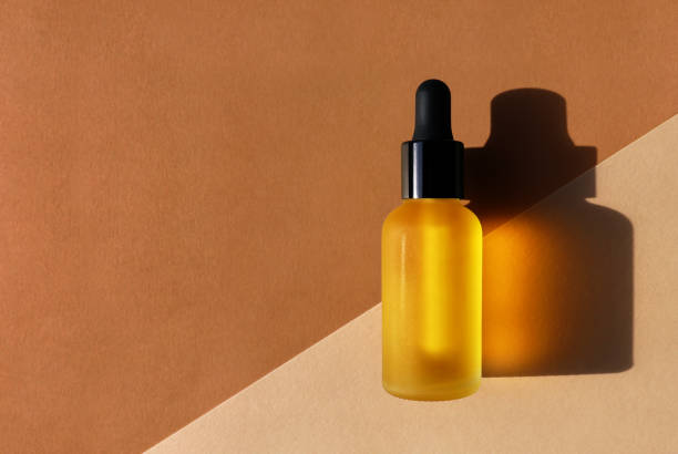 istock Cosmetic oil bottle, double diagonal background. Horizontal mockup, banner, poster, copy space 1271925109