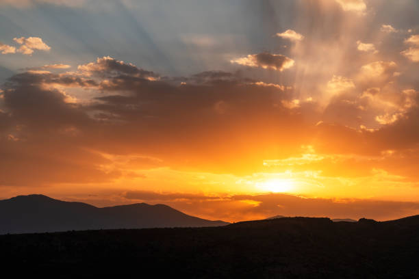 istock Beautiful bright sunset sky over the mountains silhouette . Dramatic orange clouds after sunset. Nature backgrounds. Golden sunset. 1271926597