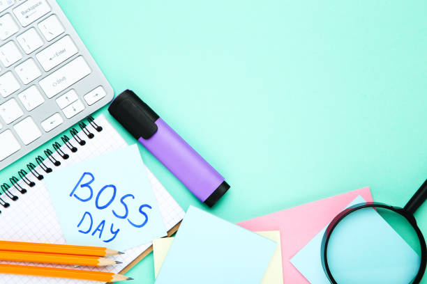 istock Text Boss Day with stickers, loupe and notepad on blue background 1271927221