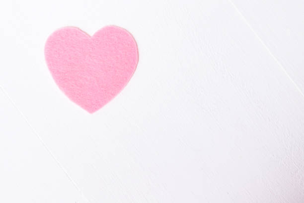 istock Felt pink heart on white background 1271928923