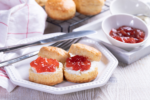 Traditional Scones with Strawberry Jam and Whipped Cream for food and nutrition, dieting and healthy eating