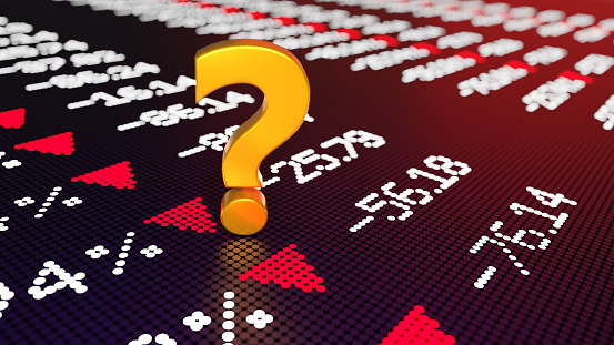 Question mark sitting over a trading board graph chart which shows a stock market crash with selective focus. Easy to crop for all your social media and print sizes with copy space.