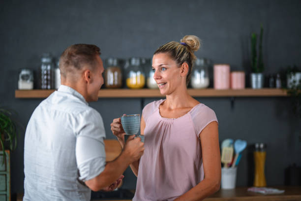 istock Happy Caucasian Couple Drinking Coffee at Home 1271931981