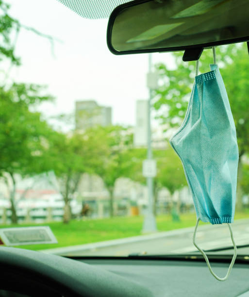 istock Face mask on the mirror of windshield 1271935007