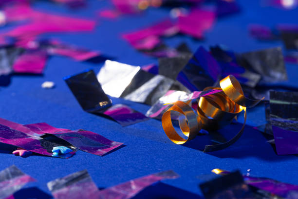 istock Glitter confetti lying on paper background close up 1271935299