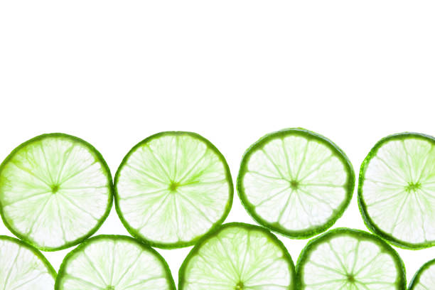 istock Green lime slices isolated on white background. 1271935582