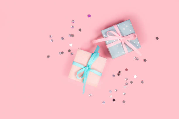 istock Cute small gift boxes on pink background. Top view. Copy space. 1271938180