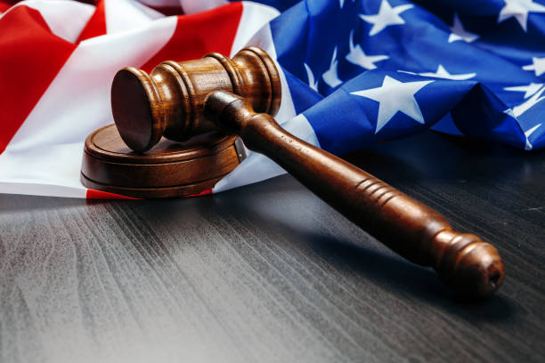 istock Gavel on wooden table with USA flag 1271939844