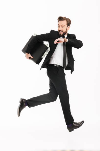 istock Excited young businessman with suitcase running 1271940132