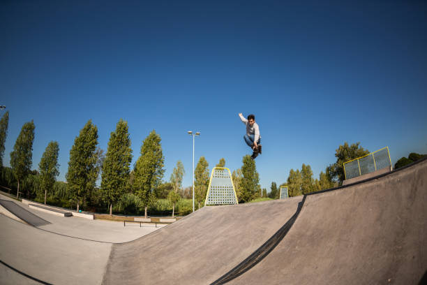 istock a roller skater jumps a ramp doing a trick in a skate park 1271940837