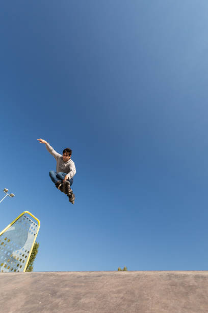 istock a roller skater jumps a ramp doing a trick in a skate park 1271940840