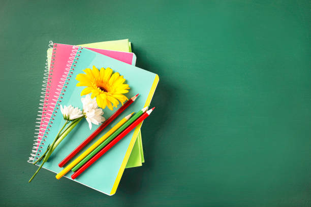 istock Teacher's day greeting card on green blackboard background. Top view. Copy space. 1271943484