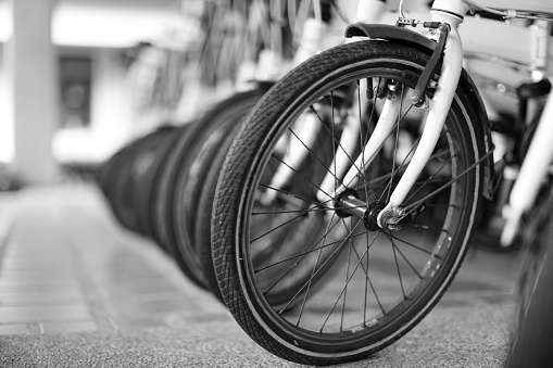 Close up the vintage bicycles in the shop as black and white photo.