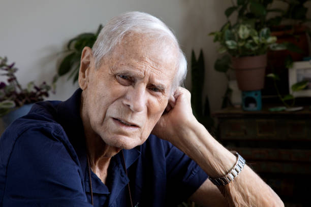 istock Senior man at home head resting on hand looking at camera 1271946679