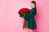 Profile photo of adorable charming chic lady hold large red long roses bouquet secret admirer boyfriend birthday surprise wear green mini dress isolated pastel pink color background