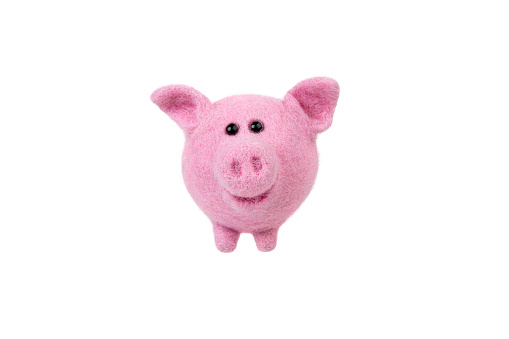 Handmade felt toy isolate on a white background. Pink piglet made of wool. Soft toy pig.