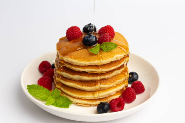 istock Delicious pancakes with raspberry and blueberry on White background 1271948517