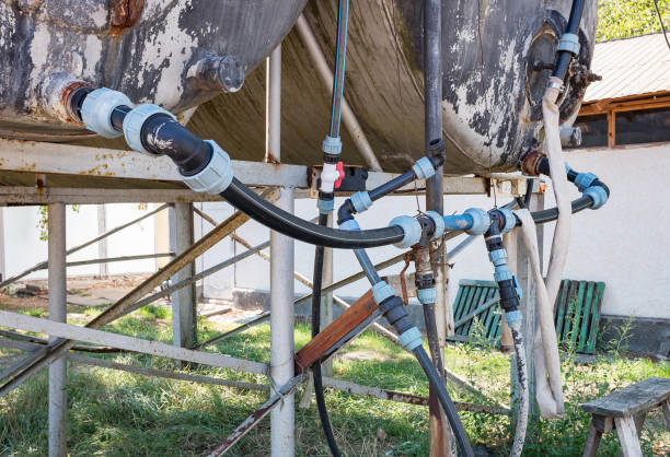 Drinking water tanks and plastic pipes with valves. The problem of drinking, fresh water in dry areas. Drinking water tanks and plastic pipes with valves. The problem of drinking, fresh water in dry areas. water System Installation Process for Livestock stock pictures, royalty-free photos & images