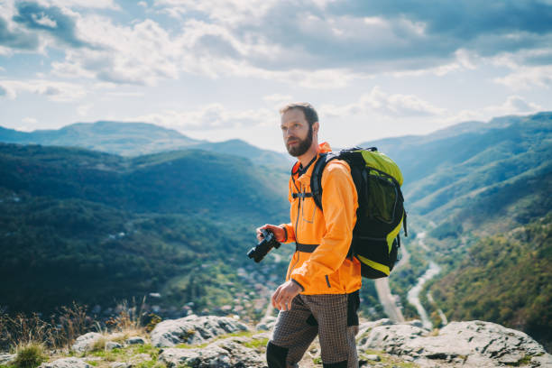 Young man taking photos on the mountain top