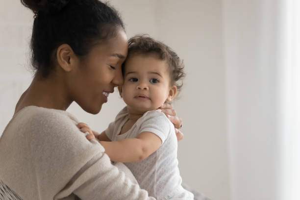 istock Bonding mixed race young mommy cuddling sweet little kid. 1271954607