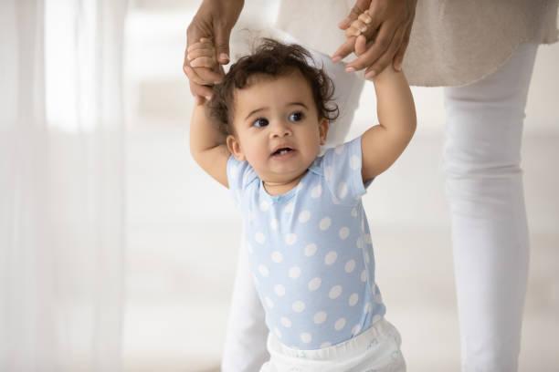 istock Curious small mixed race kid learning walking with biracial mum. 1271954611