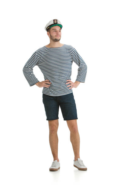 Posing confident. Caucasian male sailor in uniform on white studio background. Young man using modern devices and gadgets in his work. Concept of tech, professional occupation, job of seaman.