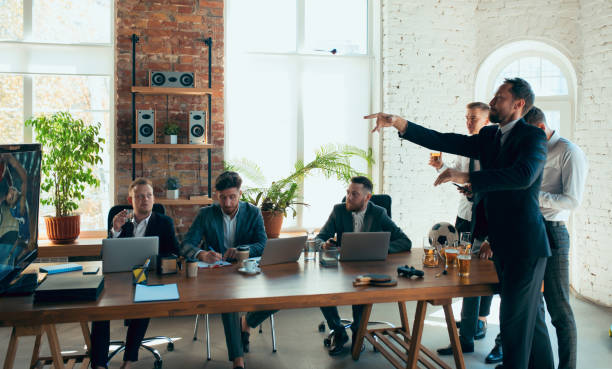 istock Happy colleagues having fun in office while their colleagues working hard 1271955911