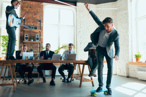 istock Happy colleagues having fun in office while their colleagues working hard 1271955938