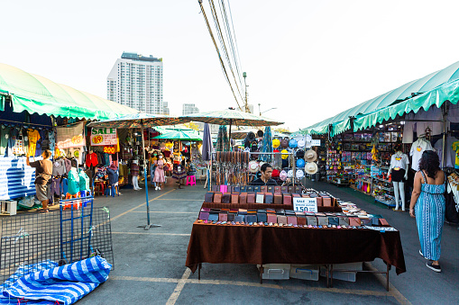 This image shows shops in Chatuchak market in bangkok. people seen Shopping at Chatuchak market in the image. - Bangkok, Thailand