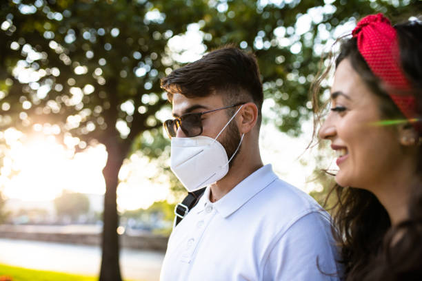 istock A young man wearing a mask while taking a walk with his girlfriend during the COVID-19 pandemic 1271959411