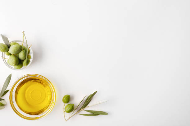 istock Bowls with oil and olives on white table top 1271959464