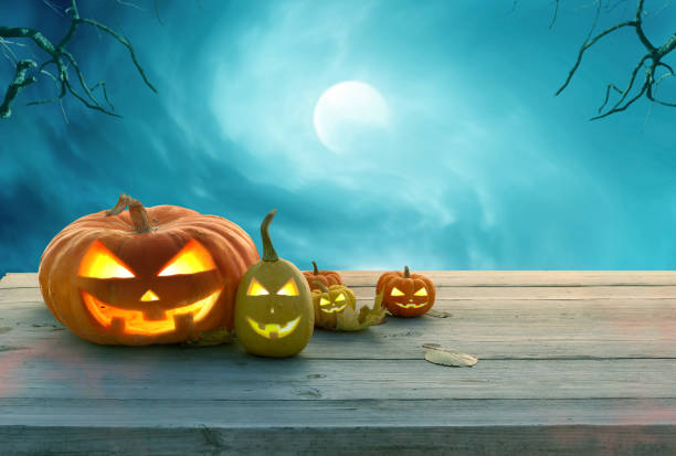 istock A pumpkins head jack o lantern on wooden table .Halloween background. 1271959945