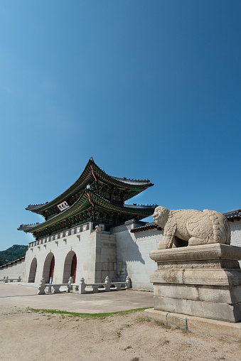 Gwanghwamun Gate in Seoul, South Korea. Gwanghwamun is the main gate leading into Gyeongbokgung Palace. Both were originally built in 1395 and both were destroyed twice over the centuries by invading Japanese forces. Today, both the gate and palace have been restored to their original state.