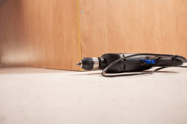 istock Drill on the white floor against the background of the closet. Empty space. 1271962472