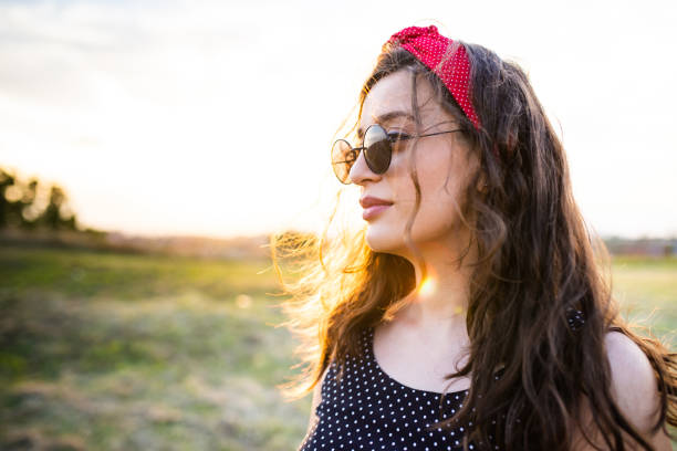 istock A beautiful young woman looking nostalgic in a park at sunset 1271963779