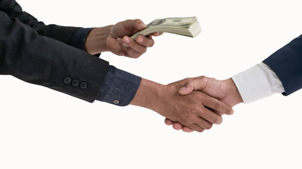 business people shaking hands rewarding money on white background - hypocrisy imagens e fotografias de stock