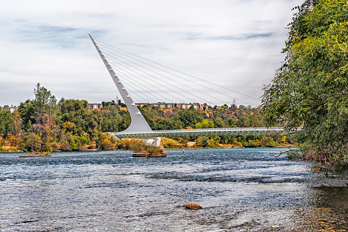 This Sun Dial Bridge a cantilever cable stayed is one of the largest in the world and located in Redding California crossing the Sacramento River with glass decked walking bridge.