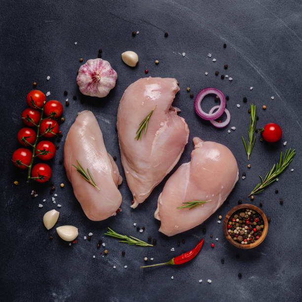 istock Raw chicken fillet with spices and herbs 1271968220