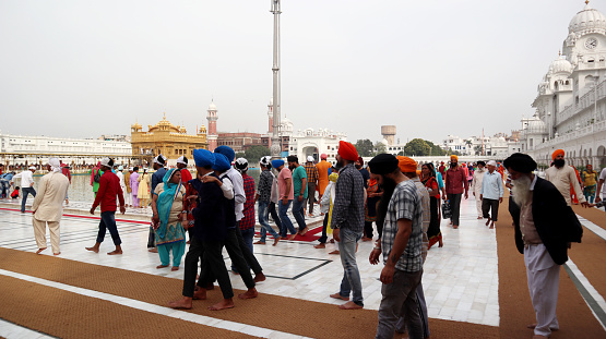 Amritsar, Punjab, India – March 29, 2019 : The Sikh holy temple The Harmandir Sahib (Golden Temple) is visited by pilgrims day and night. It is also considered to be one of the most beautiful tourist sites in India. It’s the main attraction point for visitors and tourists in Amritsar, Punjab.