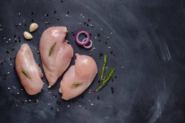 istock Raw chicken fillet with spices and herbs 1271969013