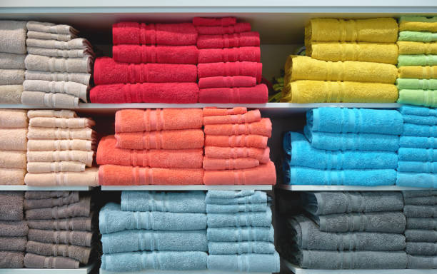 istock Stack of colorful fluffy bathing towels on shelf in shop 1271969054