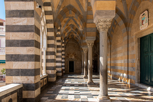View of the entrance hall and columns of Amalfi Cathedral dedicated to the Apostle Saint Andrew at Amalfi city, Italy.