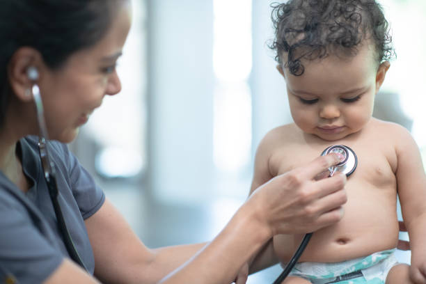 istock Visiting nurse checks on baby 1271975538
